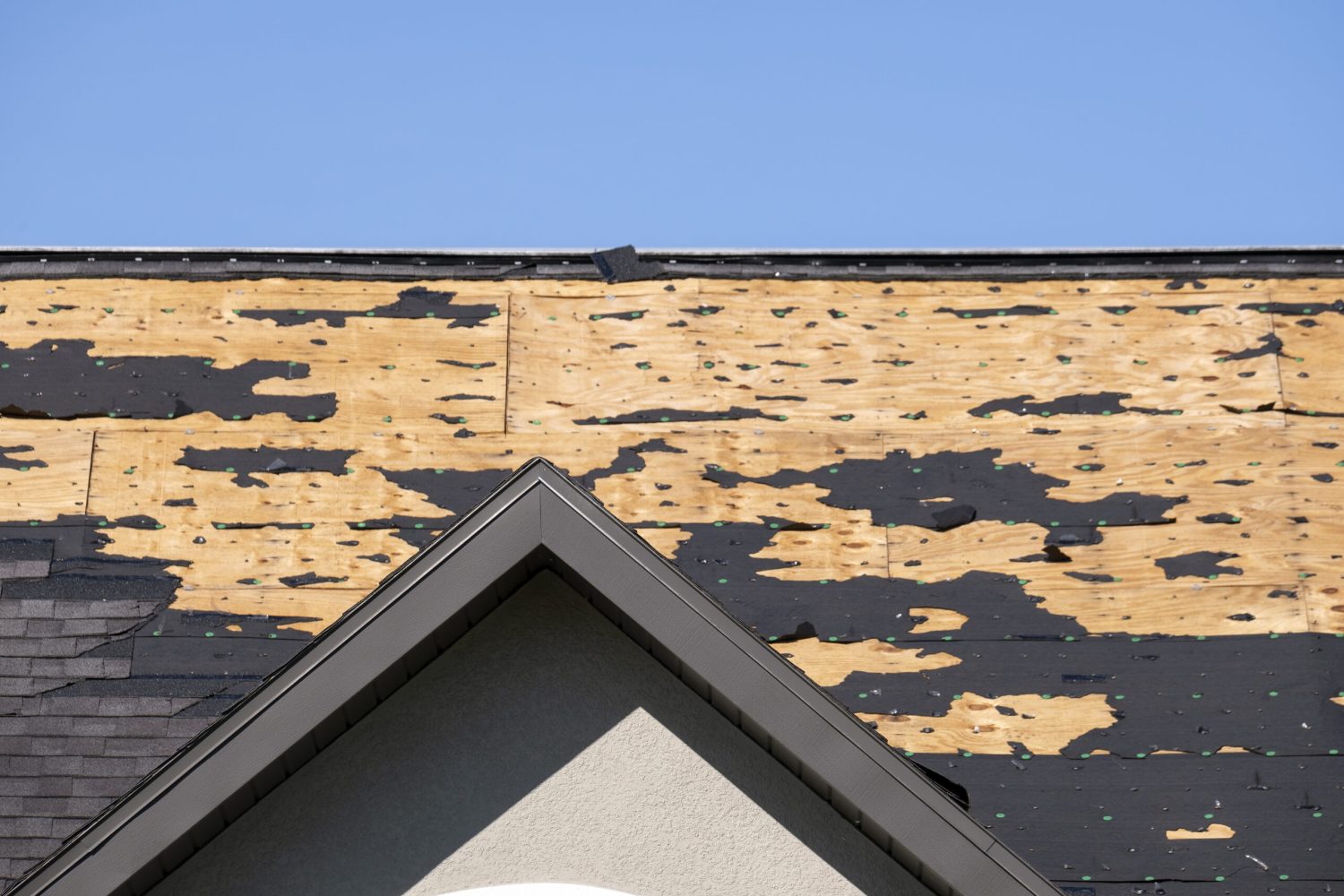 Natural disaster and its consequences. Hurricane Ian destroyed house roof in Florida residential area.